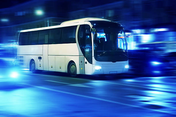tourist bus moves in the night city